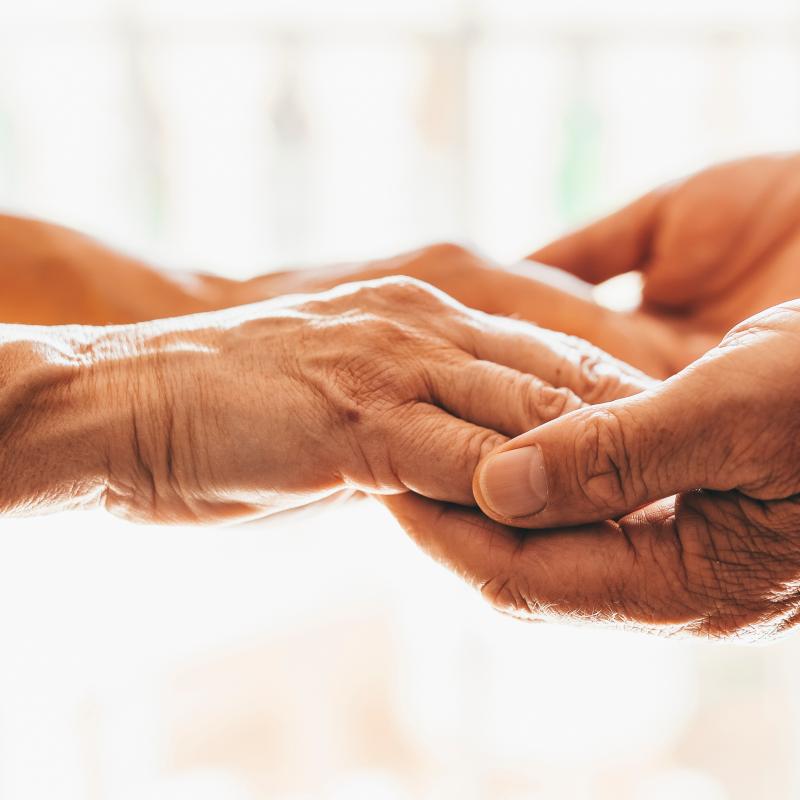 Elder people's hands holding together.