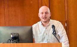 Ezra Goldstein presents at the podium.