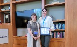 Deborah Ehrenthal, SSRI Director, and Kassidy McElwee, Research Project Manager, poses with her Above and Beyond Award.