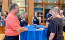 Attendees of the SSRI Spring Celebration event congregate in the Hintz Alumni Hall.