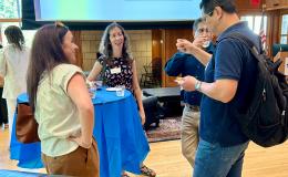 Attendees of the SSRI Spring Celebration event congregate in the Hintz Alumni Hall.