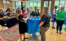 Attendees of the SSRI Spring Celebration event congregate in the Hintz Alumni Hall.