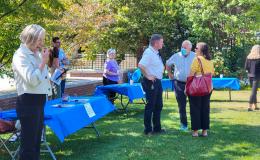 Attendees networking at the various carnival-style tables.