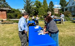 Attendees mingling outside on the Alumni Hall lawn.