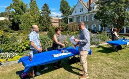 Attendees mingling outside on the Alumni Hall lawn.