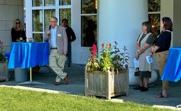 Attendees mingling outside on the Alumni Hall lawn.
