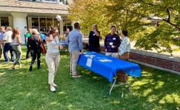 Attendees mingling at on the Alumni Hall lawn.