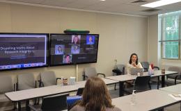 Courtney Karmelita talks to the group about research integrity.