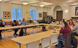 Wide shot of the attendees in 110 Henderson.