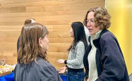 Attendees at the SSRI Open House chatting at a high-top table.