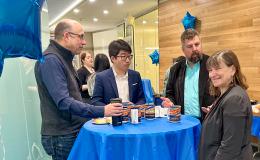 Attendees at the SSRI Open House chatting at a high-top table.