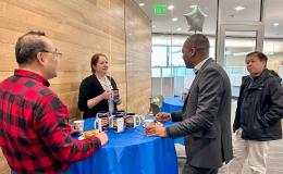 SSRI Open House attendees chatting around a high-top table.