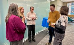 SSRI employees chatting with attendees.