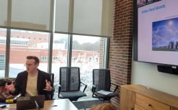 Kyle Aun, SSRI cofunded faculty member, presents to the group.
