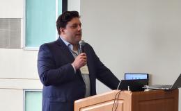 Brad Linn, Assistant Professor of Family and Community Medicine, Molecular and Precision Medicine, and Psychiatry and Behavioral Health, presents to the group.