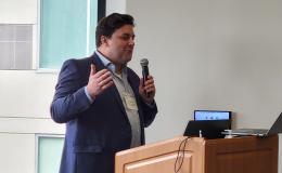 Brad Linn, Assistant Professor of Family and Community Medicine, Molecular and Precision Medicine, and Psychiatry and Behavioral Health, presents to the group.