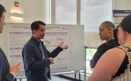Presenters from the Poster Session show off their posters.