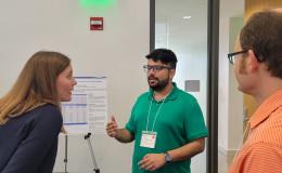 Presenters from the Poster Session show off their posters.