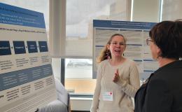 Presenters from the Poster Session show off their posters.