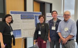 Presenters from the Poster Session show off their posters.