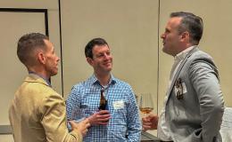 Attendees mingle at the high-top tables.