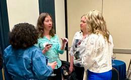 Attendees mingle at the high-top tables.