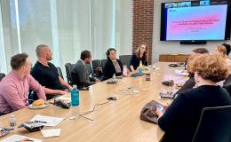 Attendees of the Faculty Flash Talks Open House engage in a discussion.