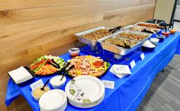Table covered in food items for retirement party attendees.