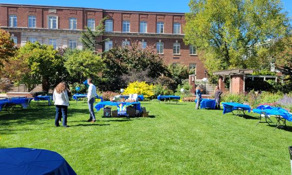 SSRI staff prepare for the Fall Welcome Event in front of the Hintz Alumni Center.
