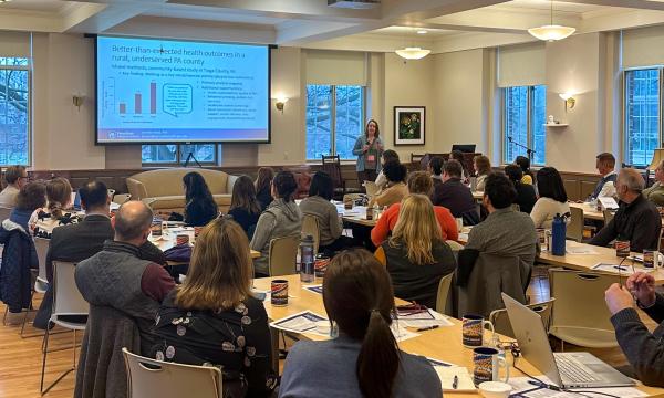 Symposium attendees engage with the various speakers and presentations.