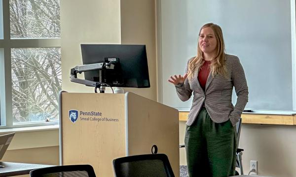 Erika Crable, a white woman with long, blonde hair presents to the group.