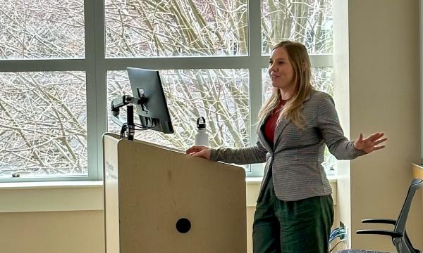 Erika Crable, a white woman with long, blonde hair presents to the group.