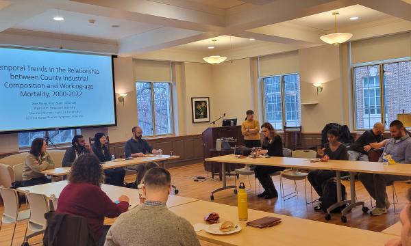 Deborah Ehrenthal, SSRI Director, welcomes attendees to the faculty flash talks open house in 110 Henderson.