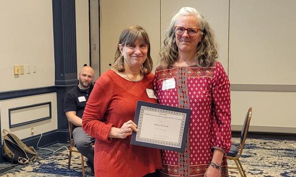 SSRI Director Deborah Ehrenthal poses with Workplace Climate winner, Diana Malcom, Senior Administrative Support at the Child Maltreatment Solutions Network.