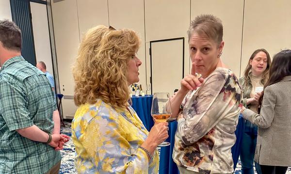 Attendees mingle at the high-top tables.